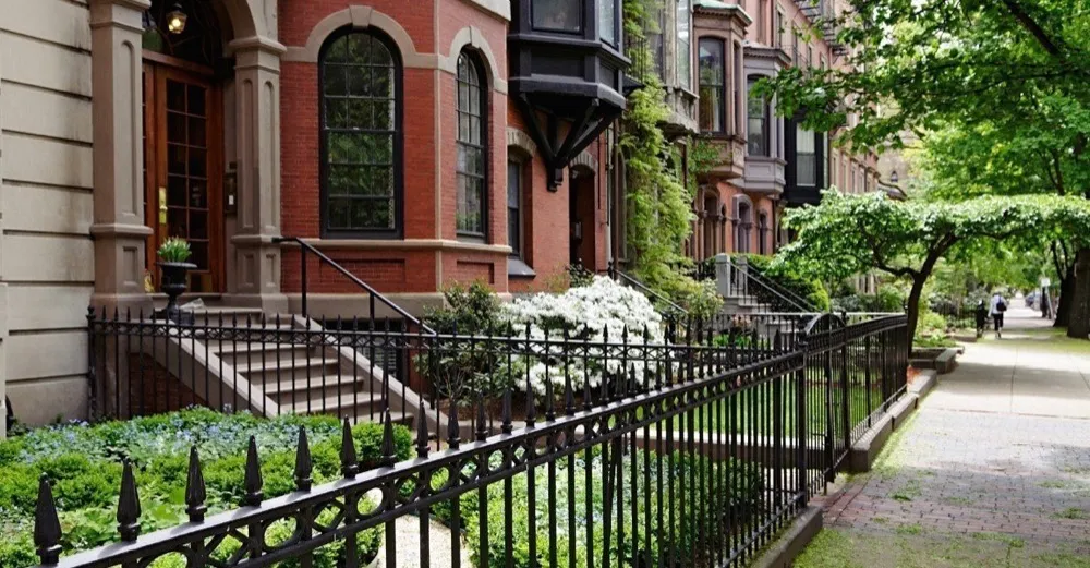 Brick brownstones and a tree-lined sidewalk in Boston