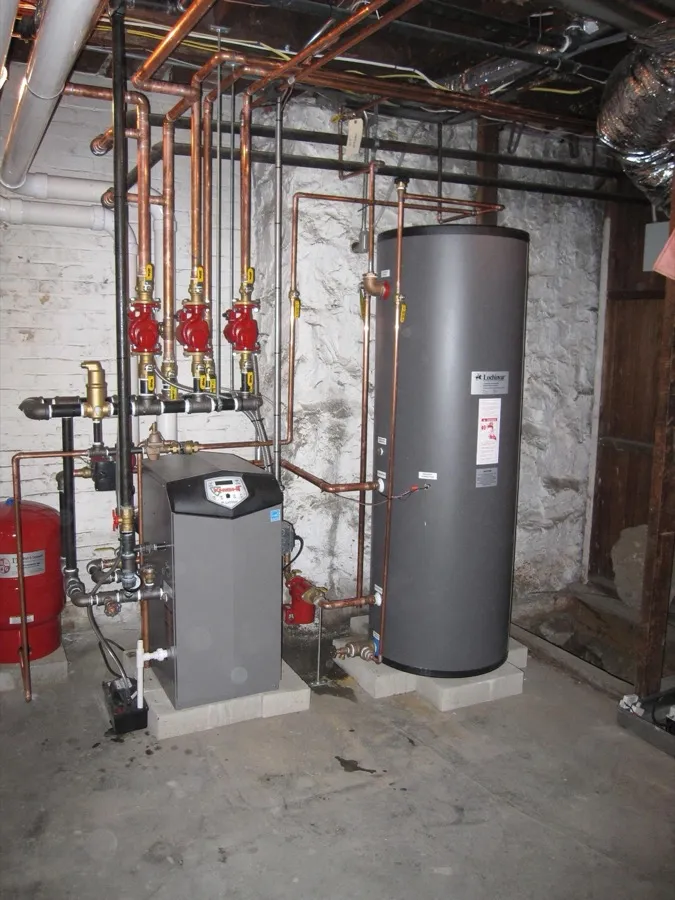 Floor-mounted high-efficiency gas boiler with indirect hot water tank and Unico high velocity AC system