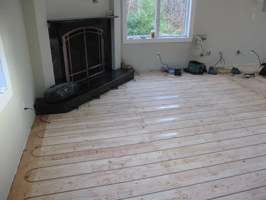 Radiant heat tubing installed in a wood subfloor